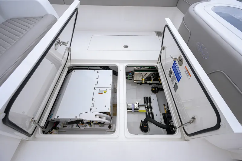 Slide: The Image of Open storage compartments on a 2022 Valhalla V-37 boat, showcasing internal equipment. - 25