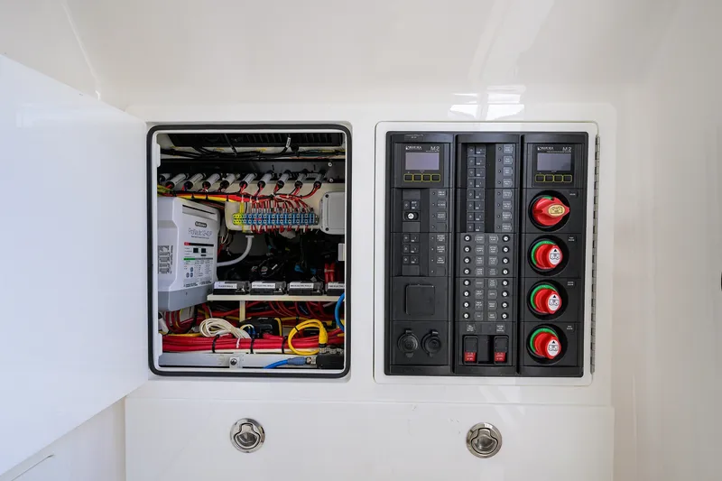 Slide: The Image of Electrical panel and wiring inside a 2022 Valhalla V-37 boat, showcasing organized components. - 63