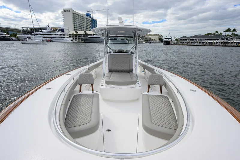 Slide: The Image of 2022 Valhalla V-37 boat with luxurious seating, docked near waterfront buildings. - 52