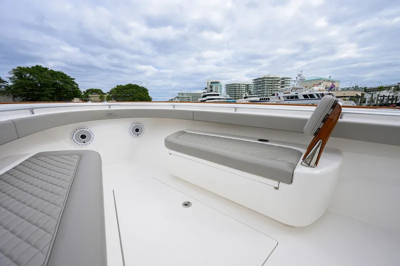 Slide: The Image of 2022 Valhalla V-37 boat interior with cushioned seating and scenic marina view. - 48