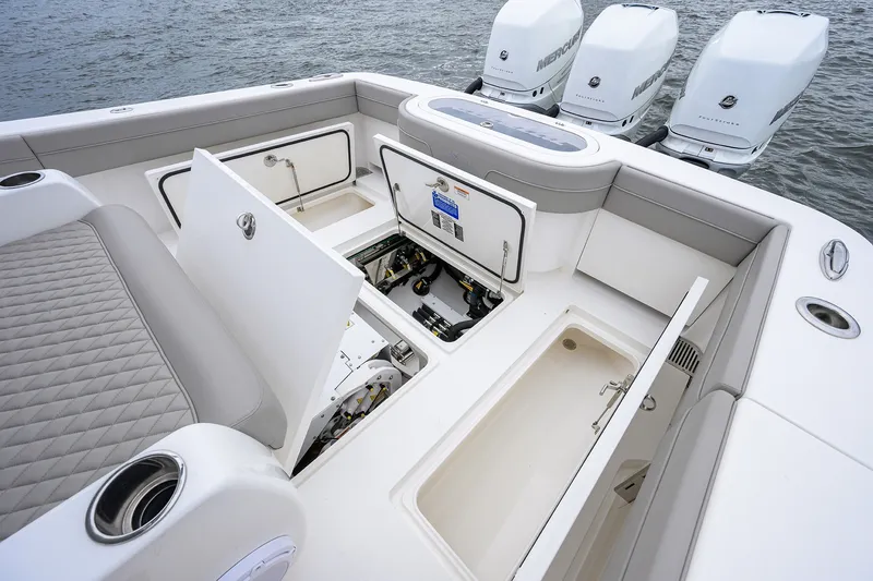 Slide: The Image of 2022 Valhalla V-37 boat deck with open storage compartments and powerful outboard engines. - 23