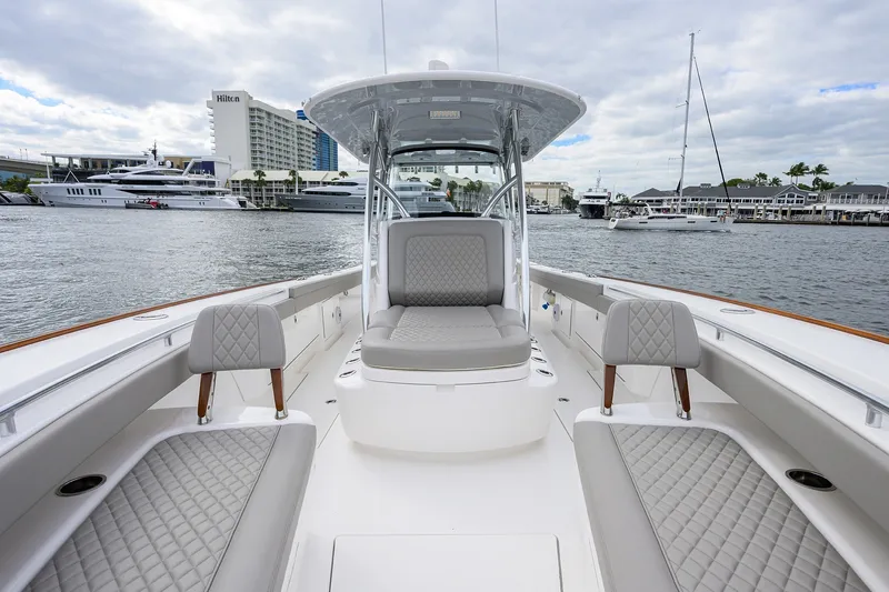 Slide: The Image of 2022 Valhalla V-37 boat interior with luxurious seating, docked at a marina. - 53