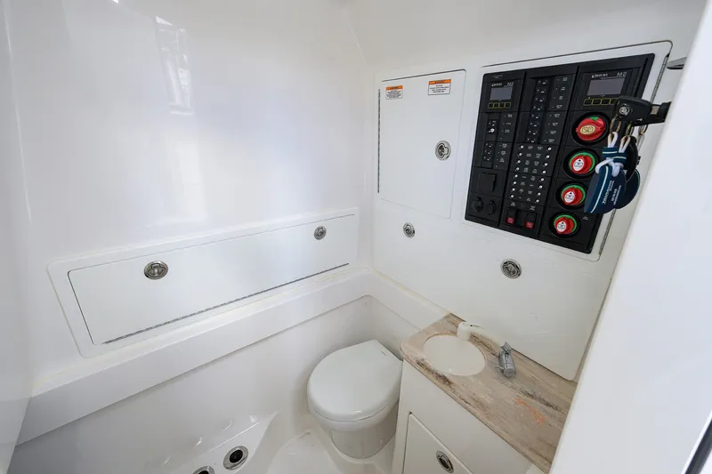 Slide: The Image of 2022 Valhalla V-37 boat interior with control panel and compact bathroom amenities. - 59