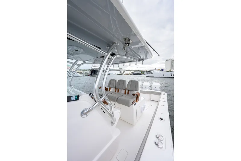 Slide: The Image of 2022 Valhalla V-37 boat interior with seating, docked near yachts. - 40