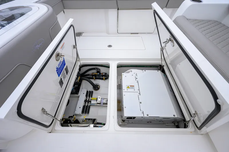 Slide: The Image of Open storage compartments on a 2022 Valhalla V-37 boat, showcasing internal equipment. - 26