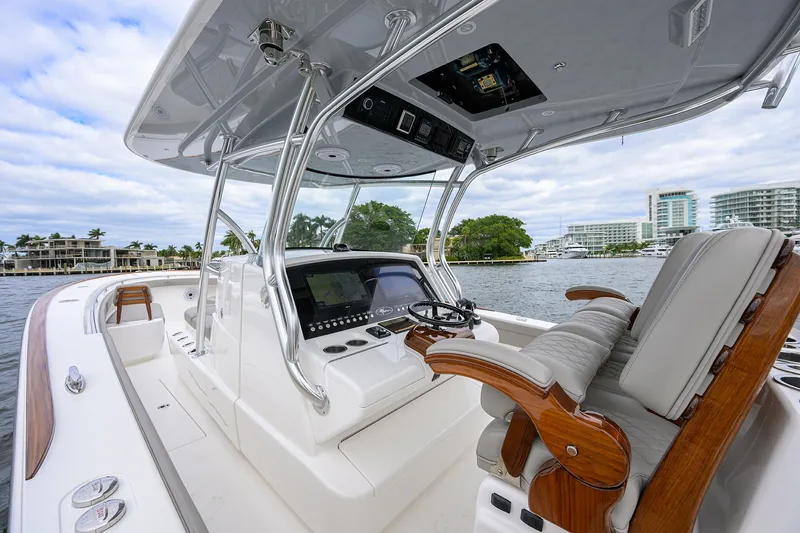 Slide: The Image of 2022 Valhalla V-37 boat interior with sleek helm and luxurious seating on a scenic waterfront. - 39