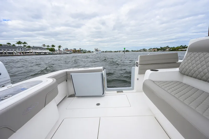 Slide: The Image of Valhalla V-37 boat interior with luxurious seating, overlooking a scenic waterfront, 2022 model. - 21