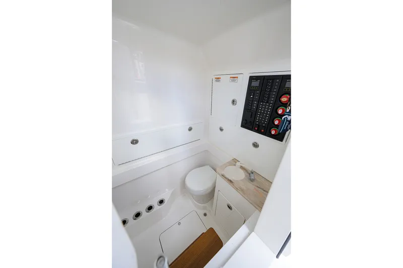 Slide: The Image of 2022 Valhalla V-37 boat interior with control panel and compact bathroom. - 58