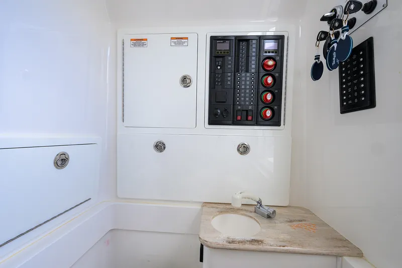 Slide: The Image of Electrical panel and storage in 2022 Valhalla V-37 boat interior. - 61