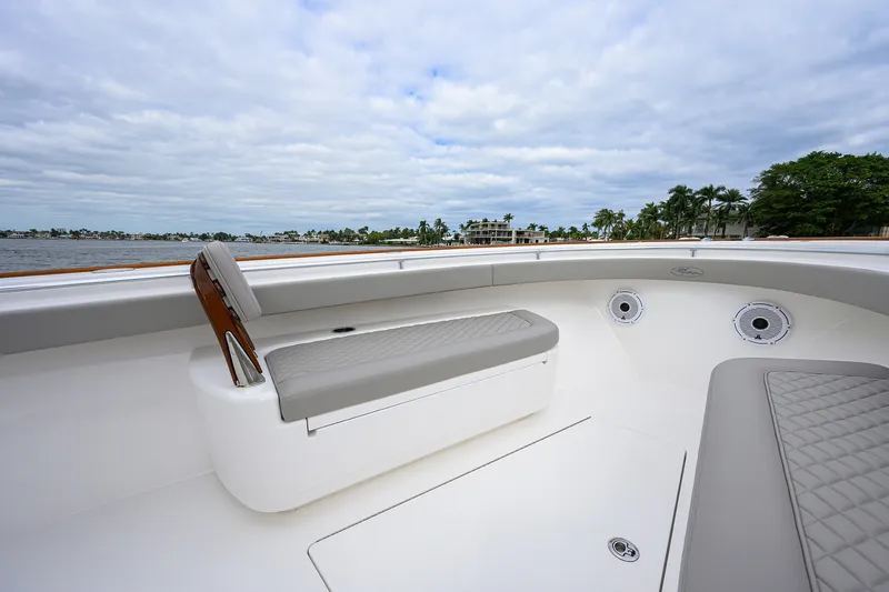 Slide: The Image of 2022 Valhalla V-37 boat interior with cushioned seating and scenic waterfront view. - 49