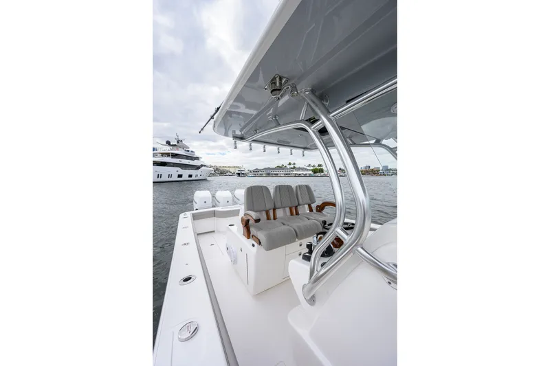 Slide: The Image of 2022 Valhalla V-37 boat interior with seating, docked near luxury yachts. - 43