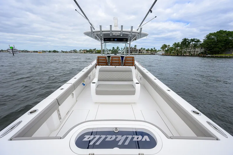 Slide: The Image of 2022 Valhalla V-37 boat interior with seating, on a calm waterway. - 13