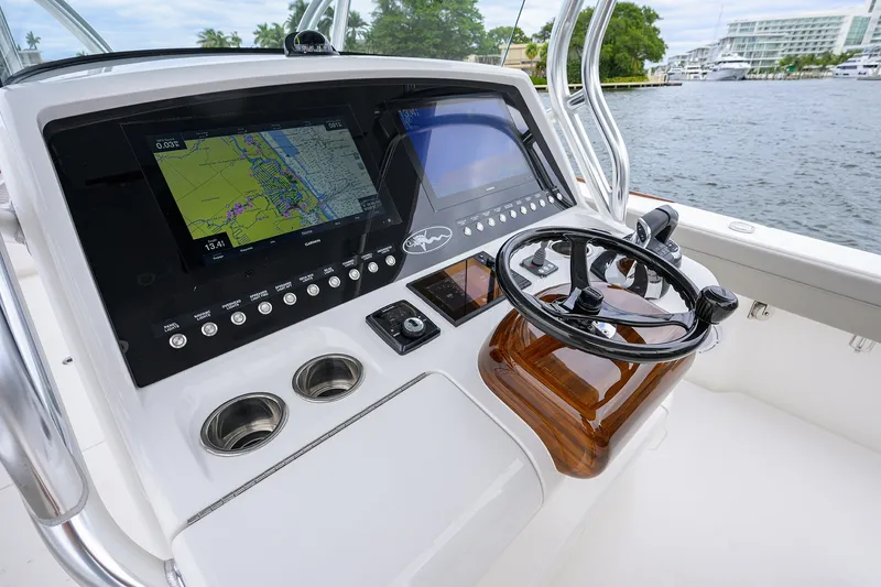 Slide: The Image of 2022 Valhalla V-37 boat dashboard with navigation screens and steering wheel. - 38