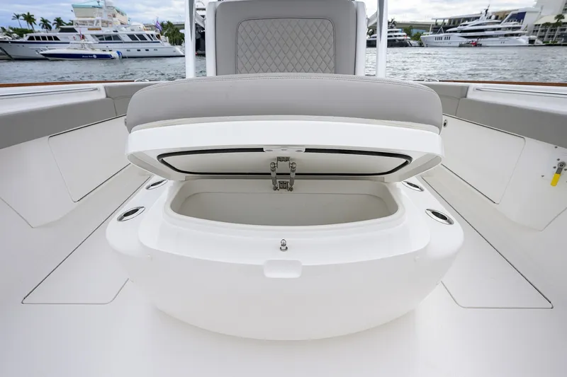Slide: The Image of Open storage compartment on 2022 Valhalla V-37 boat, docked near luxury yachts. - 56