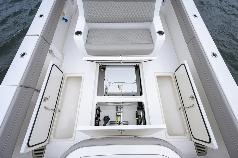Slide: The Image of 2022 Valhalla V-37 boat interior with open storage compartments and cushioned seating. - 27