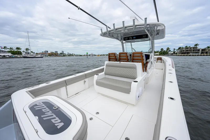 Slide: The Image of 2022 Valhalla V-37 boat with spacious deck and seating on a calm waterway. - 16