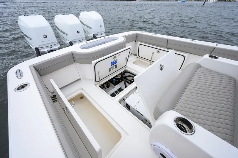 Slide: The Image of 2022 Valhalla V-37 boat with open storage compartments and triple Mercury engines. - 24