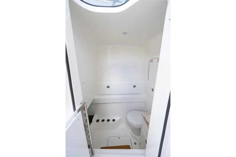 Slide: The Image of Compact bathroom interior of 2022 Valhalla V-37 boat, featuring modern fixtures and white design. - 57