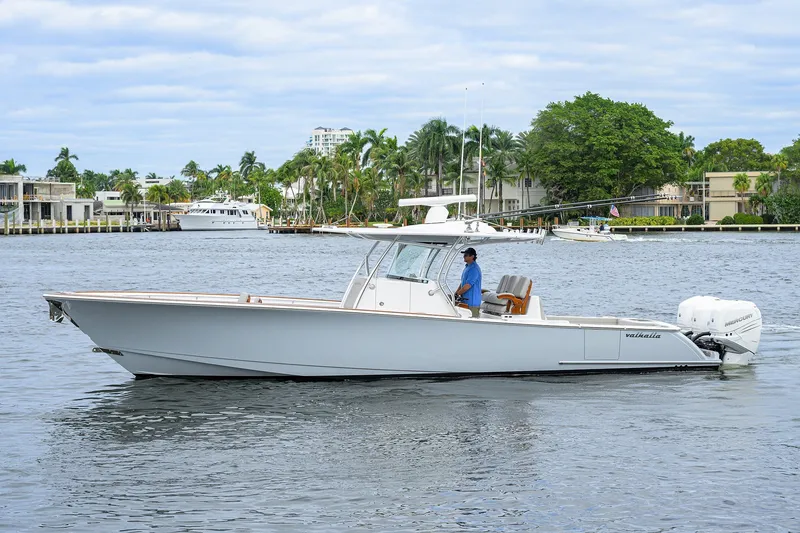The Image of 2022 Valhalla V-37 boat cruising on a scenic waterway with palm trees. - 0