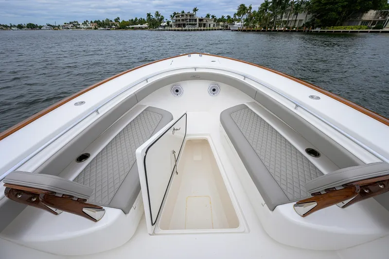 Slide: The Image of 2022 Valhalla V-37 boat interior with cushioned seating and open storage compartment. - 54