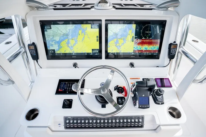 Slide: The Image of Helm of 2023 Invincible 39 Open Fisherman with dual navigation screens and controls. - 15