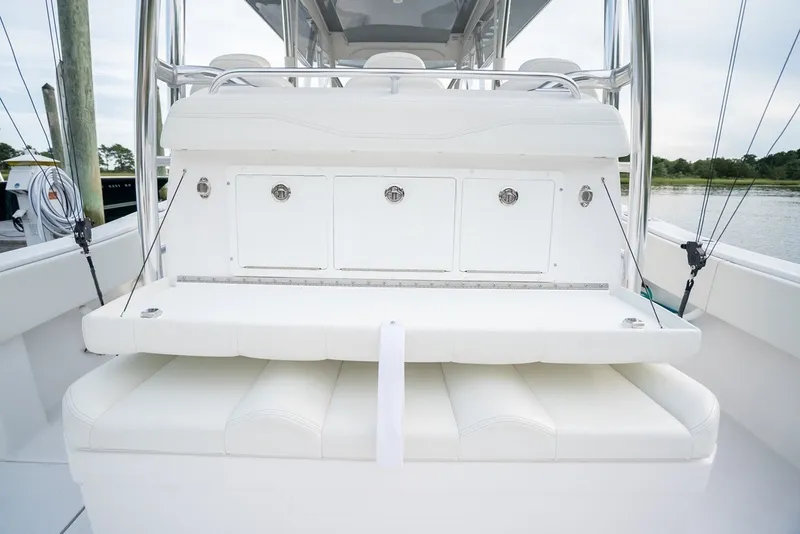 Slide: The Image of 2023 Invincible 39 Open Fisherman boat interior with white seating and storage compartments. - 24