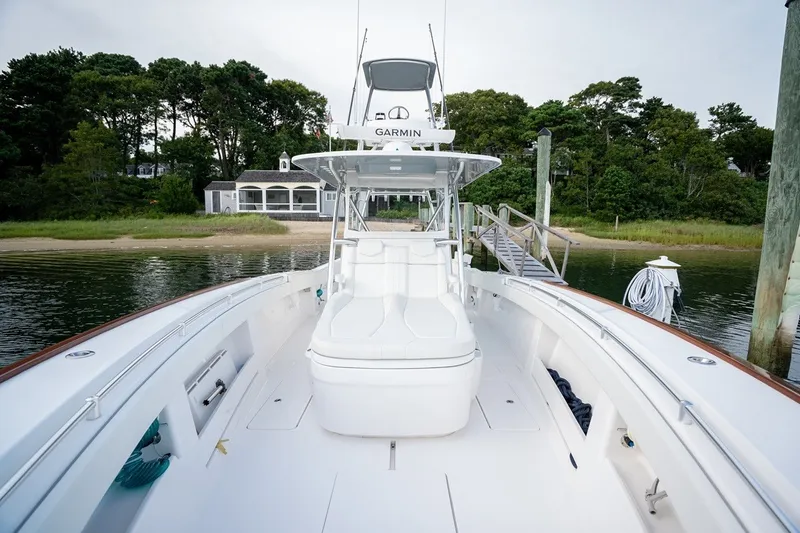 Slide: The Image of 2023 Invincible 39 Open Fisherman boat docked near a scenic shoreline. - 16