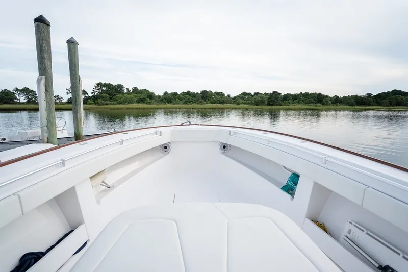 Slide: The Image of 2023 Invincible 39 Open Fisherman boat on calm water, showcasing spacious deck. - 21