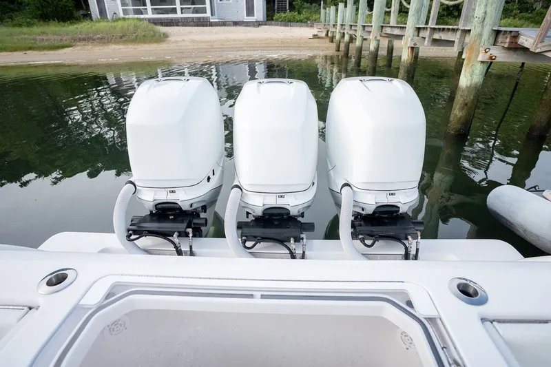 Slide: The Image of Triple outboard engines on 2023 Invincible 39 Open Fisherman boat at dock. - 13