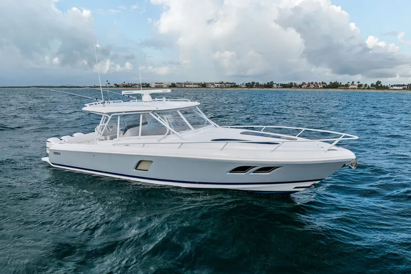 Slide: The Image of 2019 Intrepid 400 Cuddy cruising on open water under cloudy skies. - 10