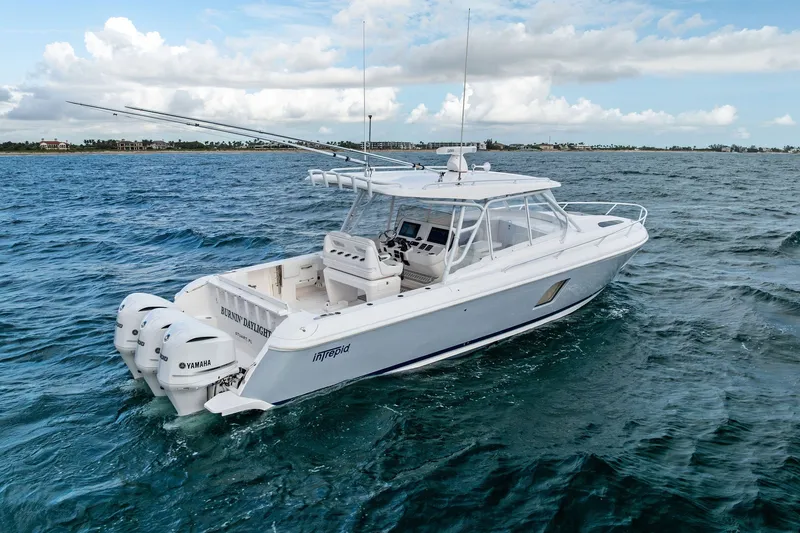 Slide: The Image of 2019 Intrepid 400 Cuddy boat cruising on open water with Yamaha engines. - 9