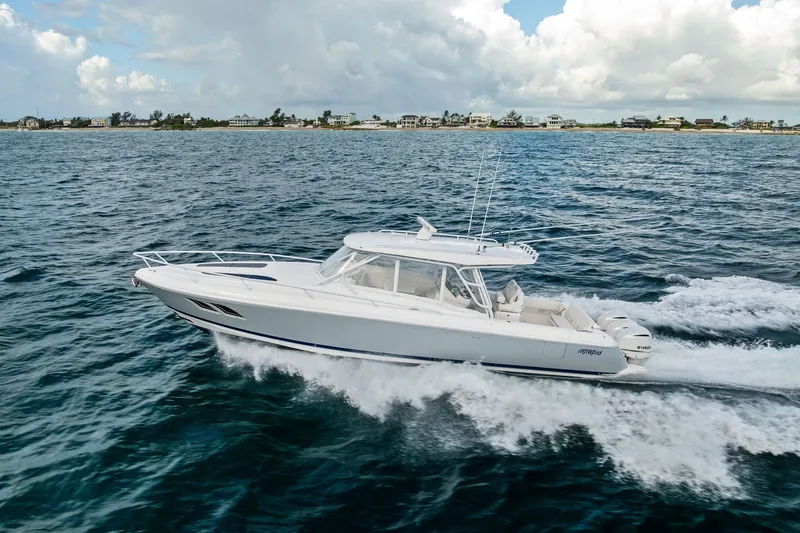 Slide: The Image of 2019 Intrepid 400 Cuddy cruising on open water under a cloudy sky. - 1