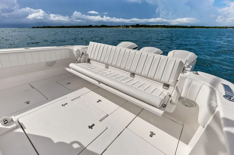 Slide: The Image of 2019 Intrepid 400 Cuddy boat with white seating, ocean backdrop, and clear skies. - 24