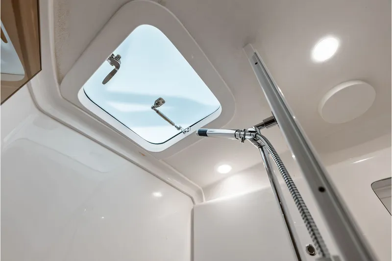Slide: The Image of Interior view of 2019 Intrepid 400 Cuddy boat's shower area with skylight. - 53