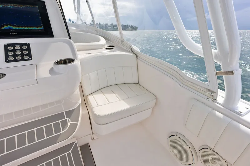 Slide: The Image of Interior view of 2019 Intrepid 400 Cuddy boat with seating and navigation display. - 16