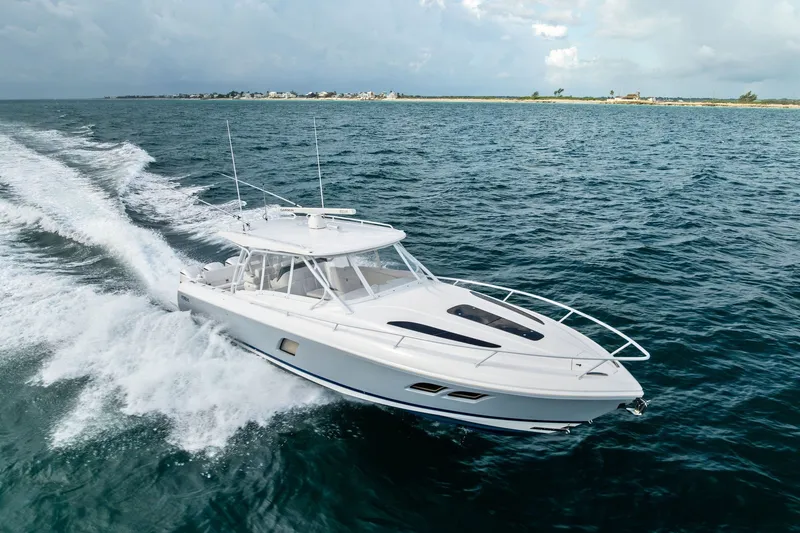 Slide: The Image of 2019 Intrepid 400 Cuddy cruising on open water, showcasing sleek design and performance. - 2