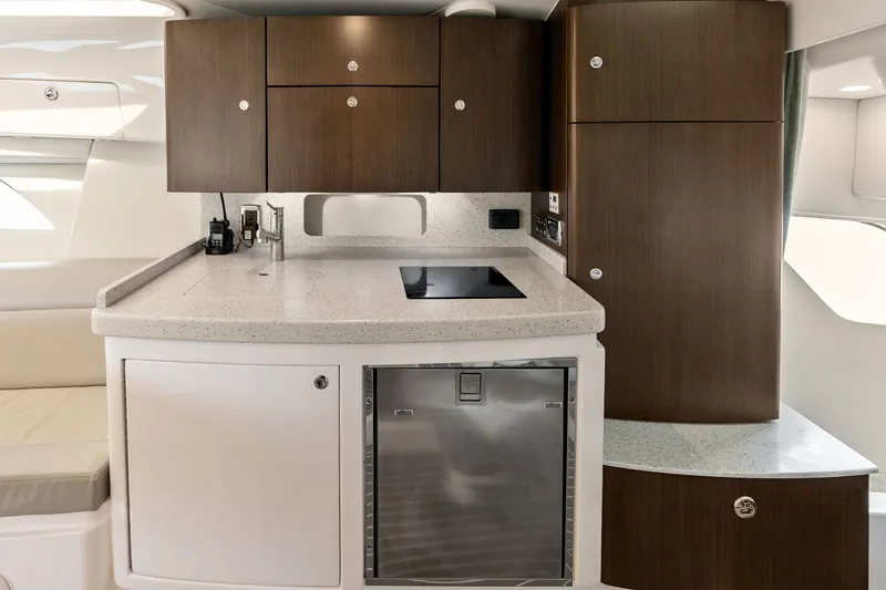 Slide: The Image of 2019 Intrepid 400 Cuddy interior kitchen with modern cabinetry and appliances. - 42
