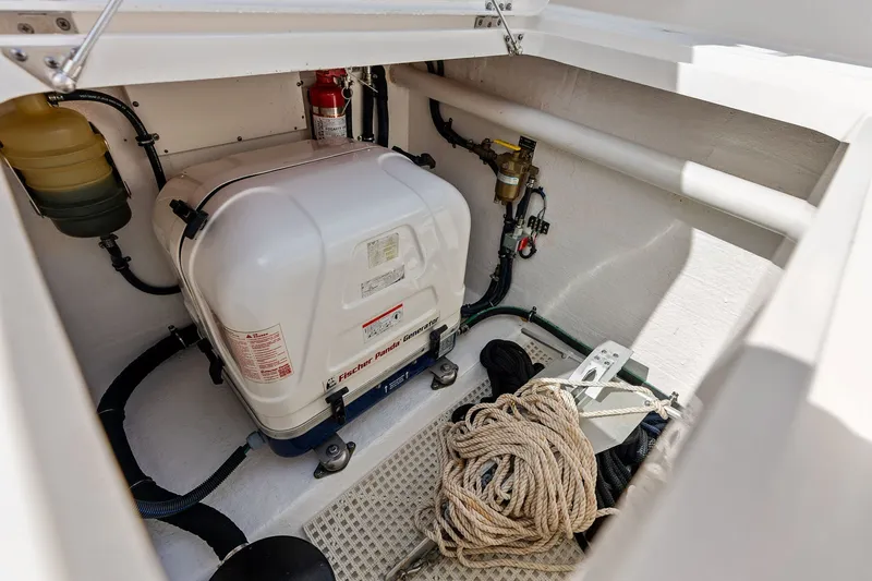 Slide: The Image of 2019 Intrepid 400 Cuddy engine compartment with generator and coiled rope. - 37
