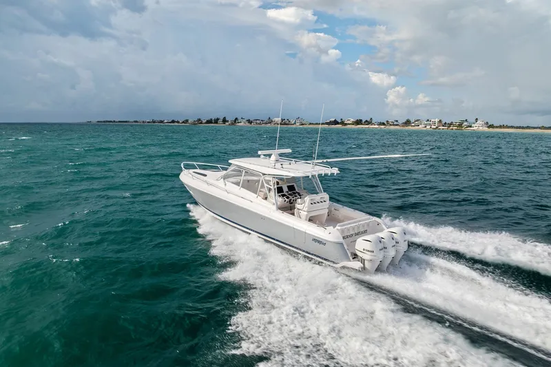 Slide: The Image of 2019 Intrepid 400 Cuddy cruising on open water under cloudy skies. - 4