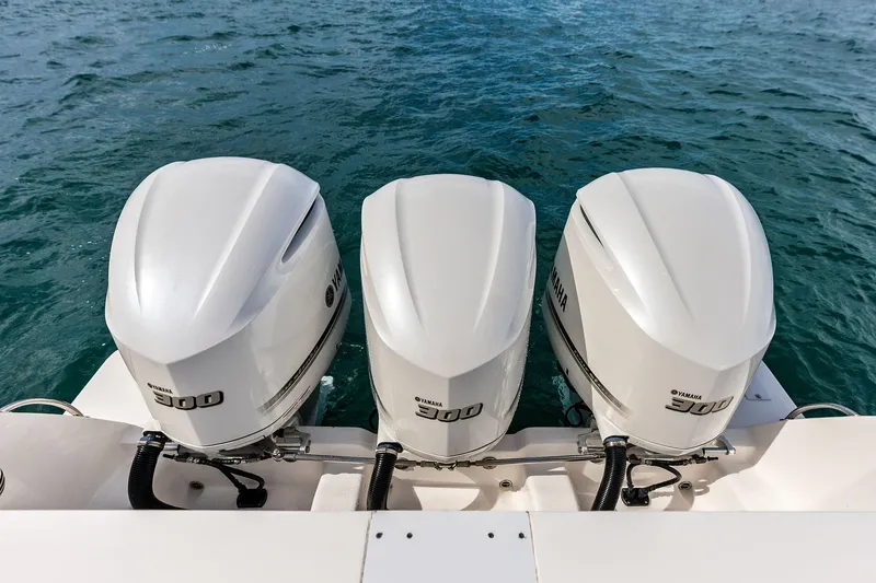 Slide: The Image of Triple Yamaha 300 engines on a 2019 Intrepid 400 Cuddy boat in the water. - 26