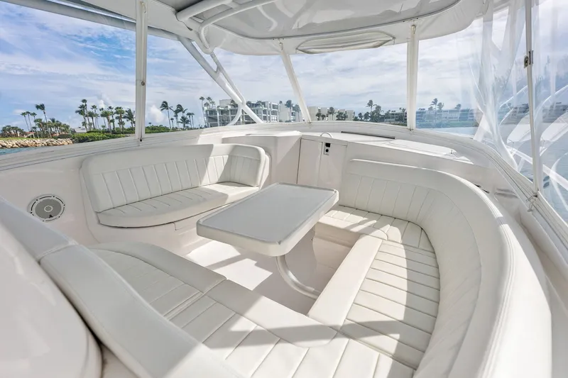 Slide: The Image of Luxurious 2019 Intrepid 400 Cuddy boat interior with white seating and table, ocean view. - 29