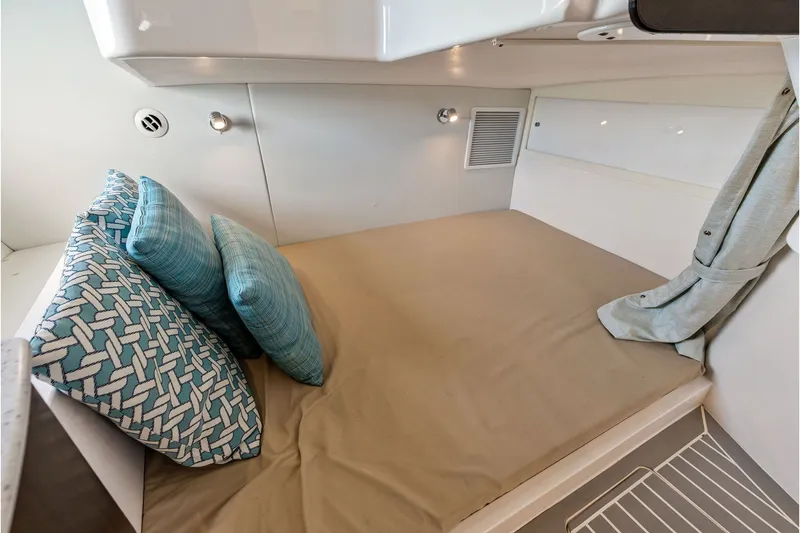 Slide: The Image of 2019 Intrepid 400 Cuddy cabin with cozy bed and decorative pillows. - 44
