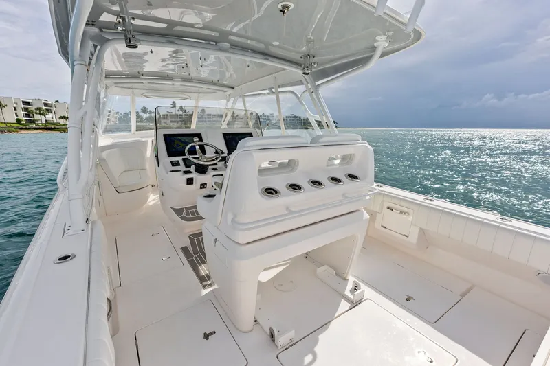 Slide: The Image of 2019 Intrepid 400 Cuddy boat interior with helm, ocean view, and modern design. - 19