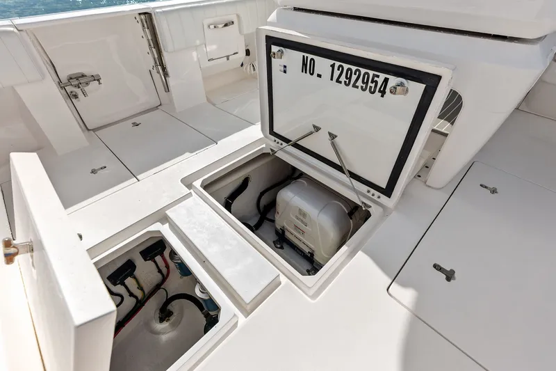 Slide: The Image of Open storage compartments on a 2019 Intrepid 400 Cuddy boat deck. - 36