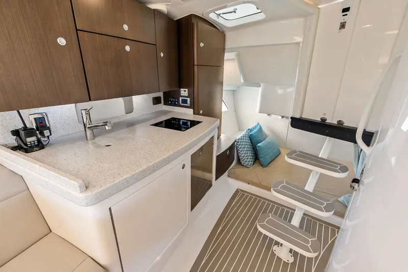 Slide: The Image of Modern 2019 Intrepid 400 Cuddy interior with kitchenette and cozy seating area. - 40