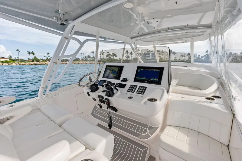 Slide: The Image of 2019 Intrepid 400 Cuddy boat interior with modern navigation system and luxurious seating. - 12