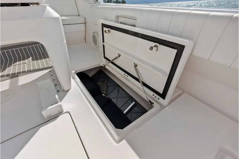 Slide: The Image of Open storage compartment on 2019 Intrepid 400 Cuddy boat deck. - 33