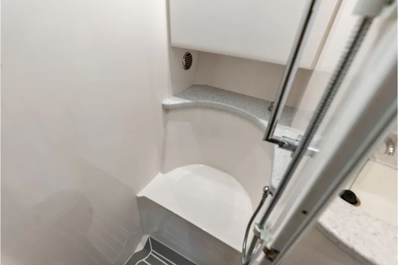 Slide: The Image of Interior of 2019 Intrepid 400 Cuddy boat bathroom with modern fixtures. - 52