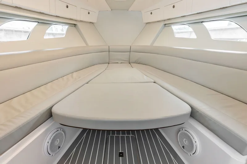 Slide: The Image of Interior of 2019 Intrepid 400 Cuddy boat with cushioned seating and windows. - 49