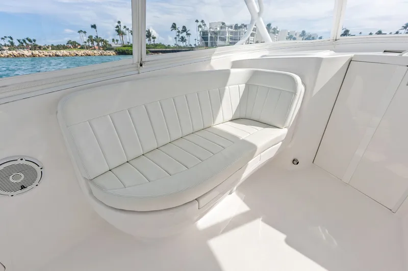 Slide: The Image of 2019 Intrepid 400 Cuddy interior with white cushioned seating and ocean view. - 30